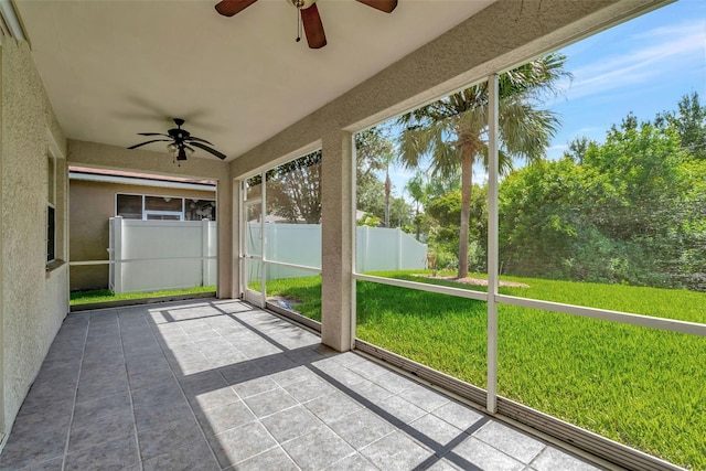 unfurnished sunroom featuring ceiling fan