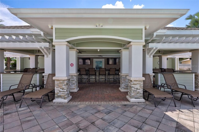 view of patio with a pergola, ceiling fan, and an outdoor bar