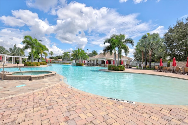 view of swimming pool with a community hot tub and a patio