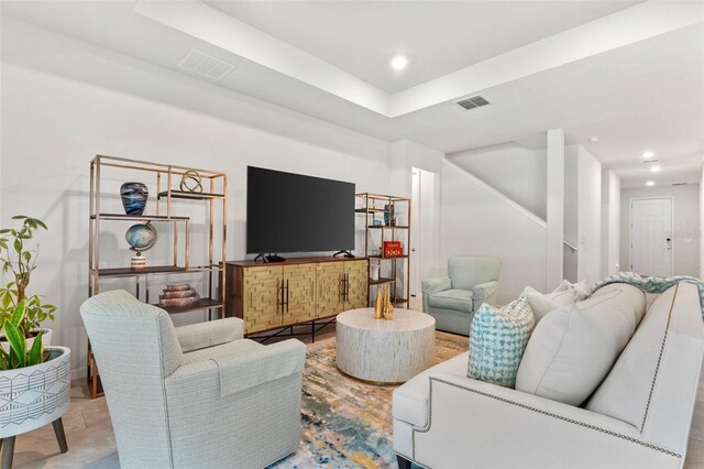 living room featuring a raised ceiling