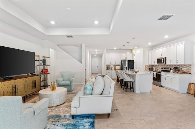 living room featuring a tray ceiling