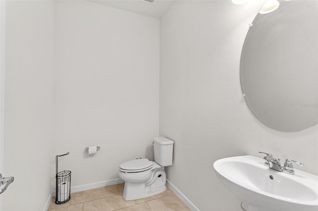 bathroom with tile patterned flooring, sink, and toilet