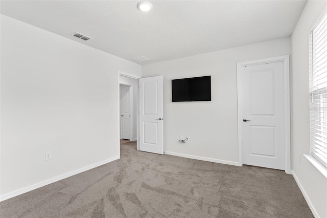 unfurnished bedroom with light carpet