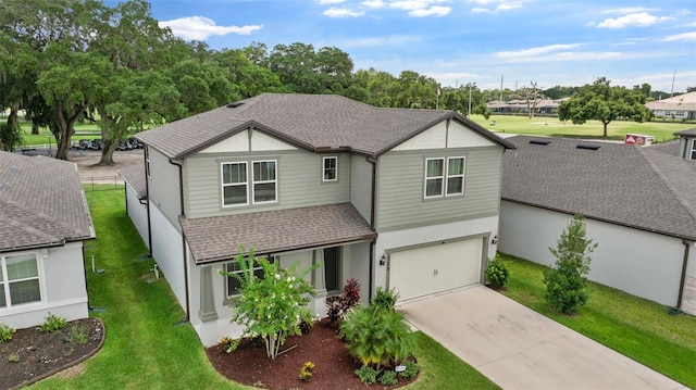 view of front of home with a garage and a front yard