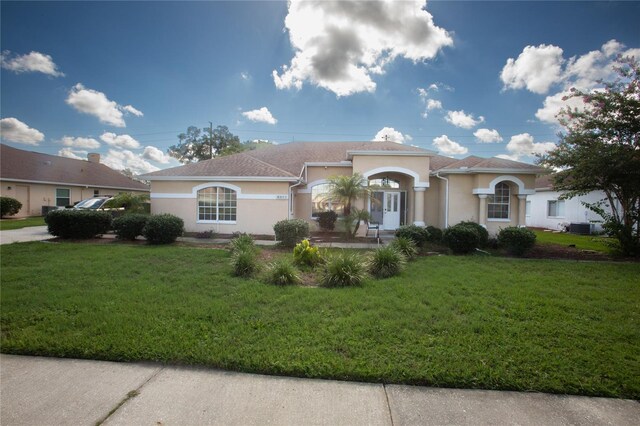 mediterranean / spanish-style home with a front yard