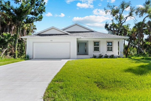 view of front of home with a front lawn and a garage