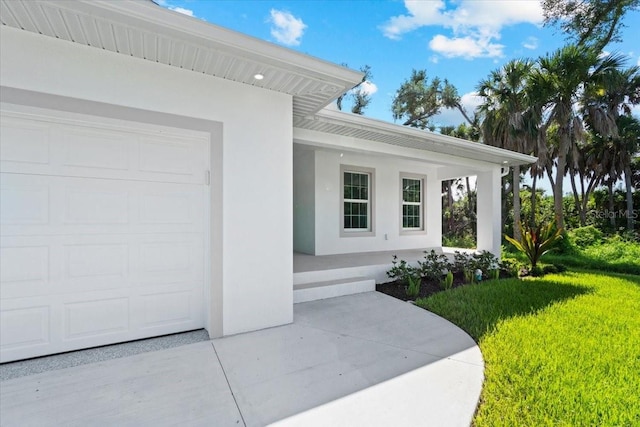 property entrance with a yard and a garage