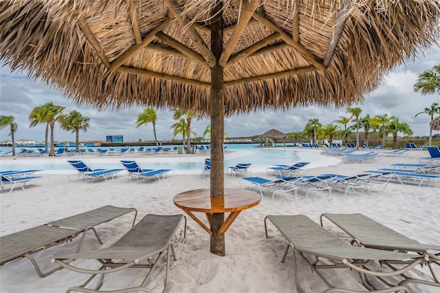 view of swimming pool featuring a water view and a gazebo