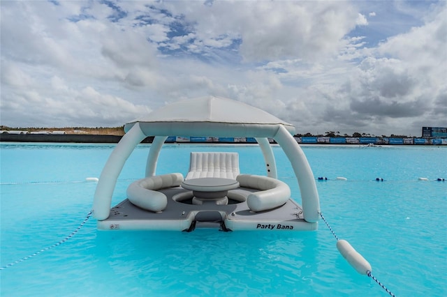 view of pool featuring a water view