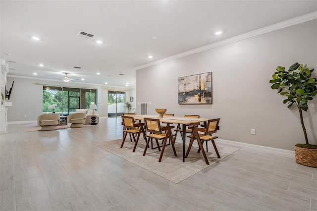 dining space with ceiling fan and crown molding