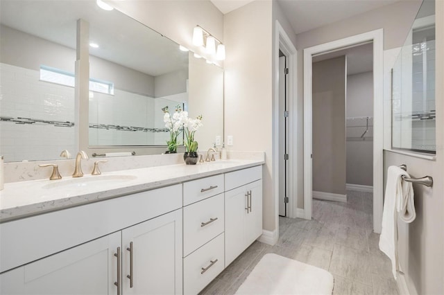 bathroom with vanity and tiled shower