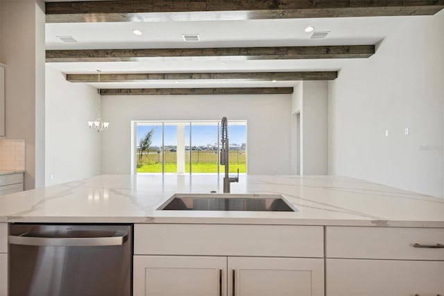 kitchen with white cabinets, light stone countertops, stainless steel dishwasher, beamed ceiling, and sink