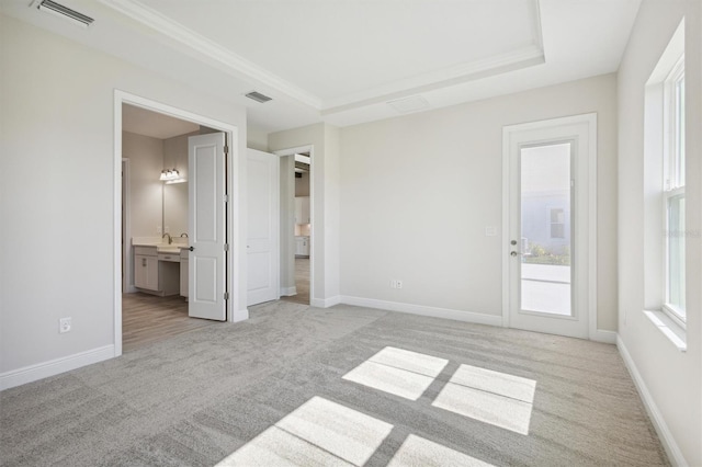unfurnished bedroom featuring light colored carpet, visible vents, and access to outside