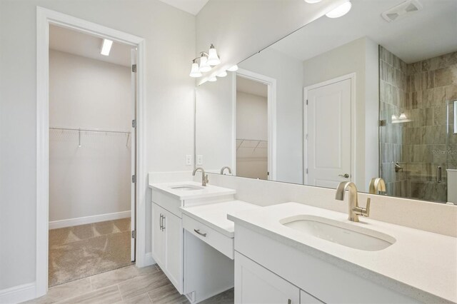 full bath featuring a sink, a shower stall, double vanity, and visible vents
