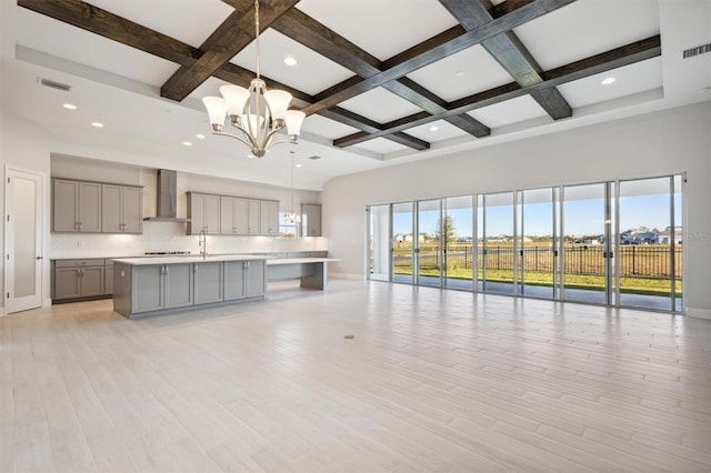 10426 Longmeadow Ave, Parrish, FL 34219 - unfurnished living room with a chandelier, coffered ceiling, beamed ceiling, light wood-style floors, and a towering ceiling