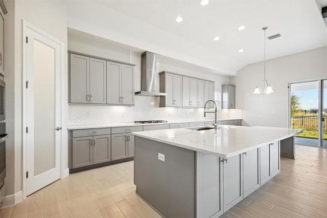 10426 Longmeadow Ave, Parrish, FL 34219 - kitchen featuring gray cabinets, wall chimney range hood, a sink, light wood-style floors, and recessed lighting