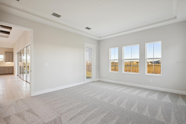 10426 Longmeadow Ave, Parrish, FL 34219 - unfurnished room featuring light carpet, a raised ceiling, and baseboards
