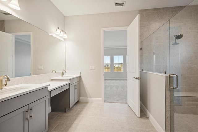 bathroom featuring tile patterned floors, a shower with door, and vanity