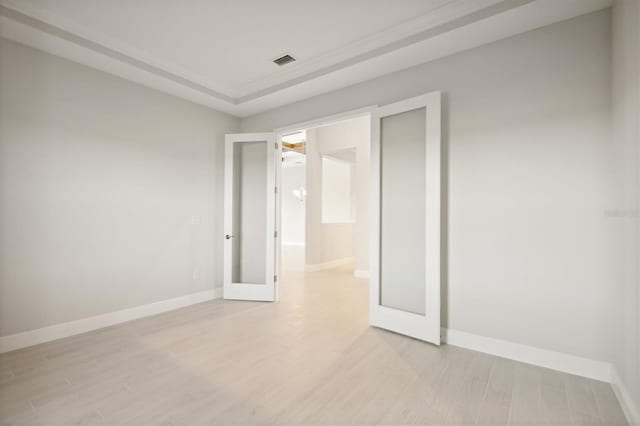 10426 Longmeadow Ave, Parrish, FL 34219 - empty room featuring light wood-style floors, baseboards, and french doors