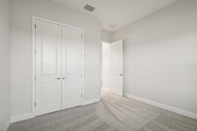 unfurnished bedroom with carpet and a closet