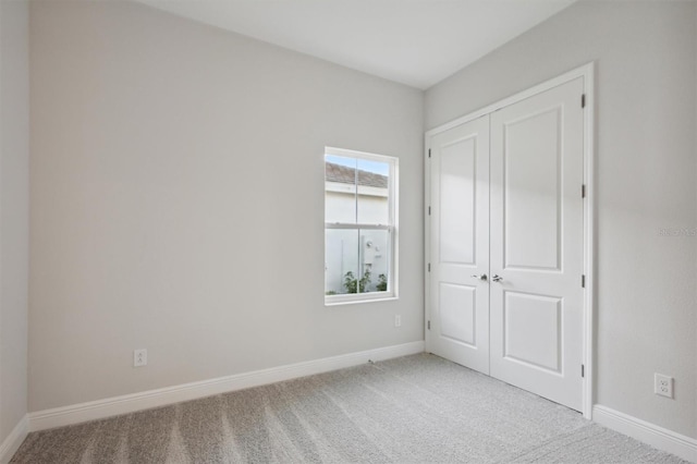 unfurnished bedroom with carpet flooring and a closet