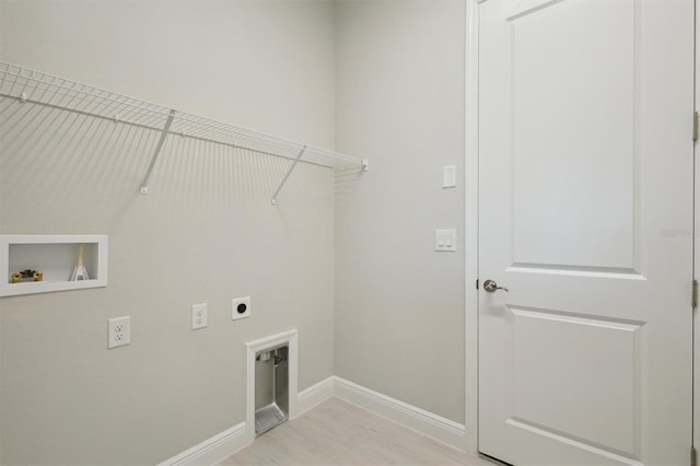 10426 Longmeadow Ave, Parrish, FL 34219 - laundry area featuring hookup for an electric dryer, hookup for a washing machine, baseboards, and light wood-style floors