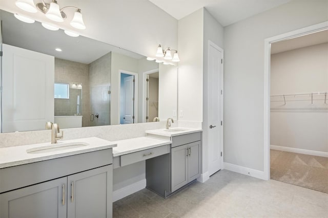 10324 Longmeadow Ave, Parrish, FL 34219 - full bath with double vanity, a tile shower, a walk in closet, baseboards, and tile patterned flooring