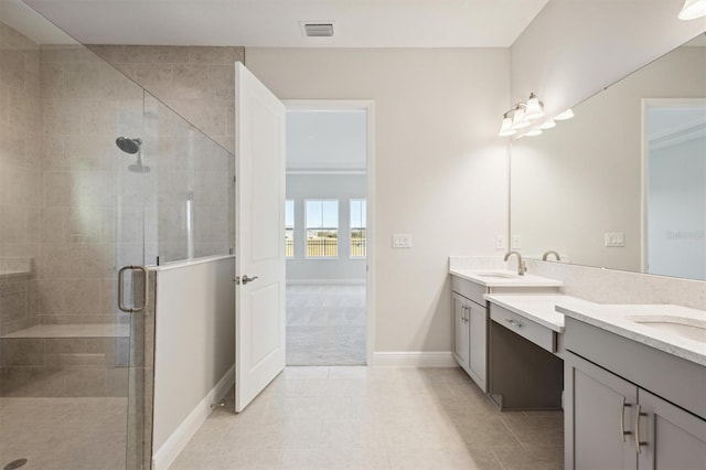 10324 Longmeadow Ave, Parrish, FL 34219 - bathroom with double vanity, a stall shower, baseboards, and tile patterned floors