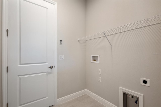 clothes washing area featuring hookup for an electric dryer, washer hookup, and light wood-type flooring