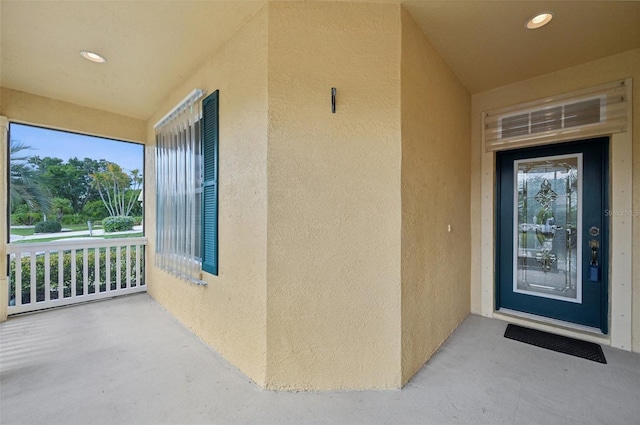 view of exterior entry with covered porch