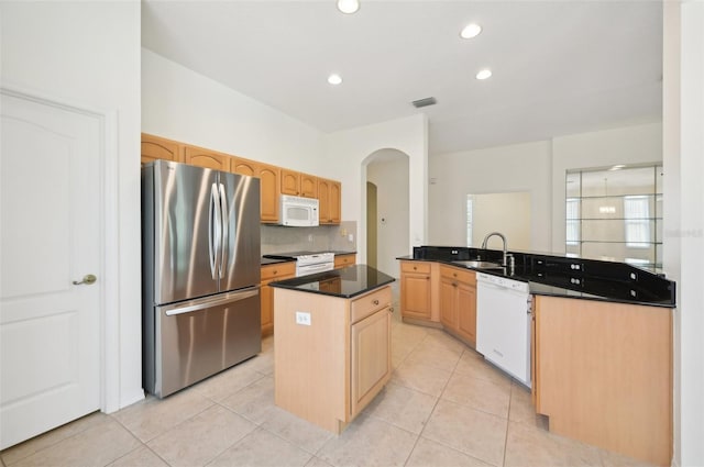 kitchen with a center island, light tile patterned flooring, white appliances, and sink