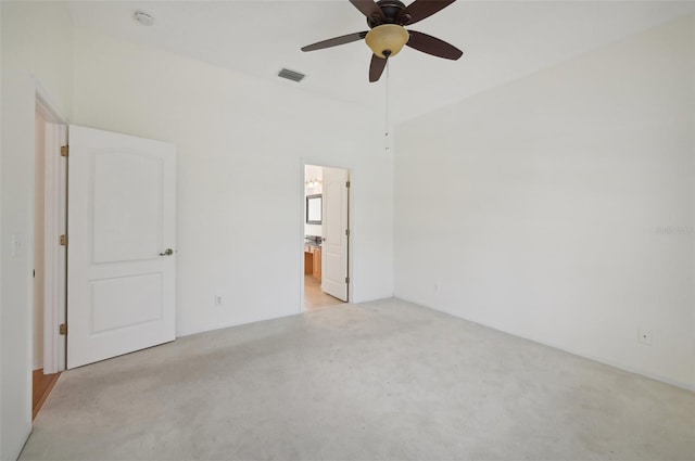 carpeted spare room featuring ceiling fan