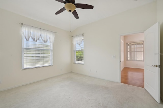 spare room with light colored carpet and ceiling fan