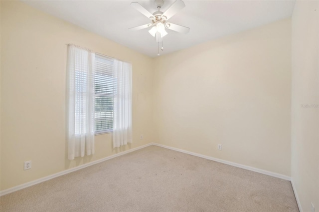 empty room with ceiling fan and light carpet