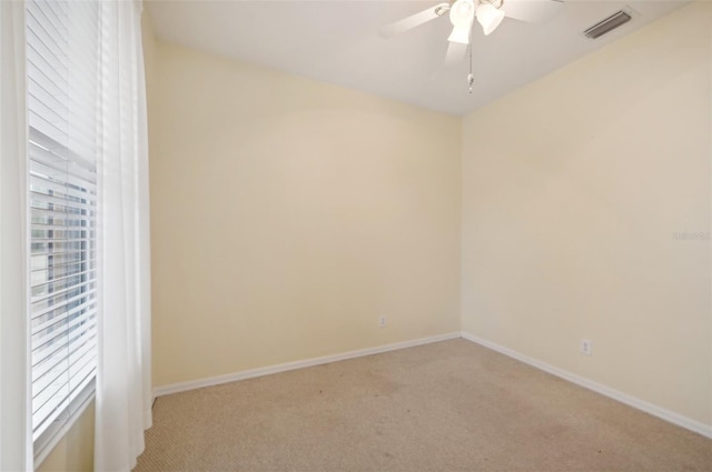 unfurnished room featuring light carpet and ceiling fan