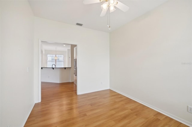 unfurnished room with hardwood / wood-style floors and ceiling fan