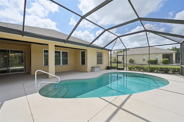 view of swimming pool with glass enclosure and a patio area