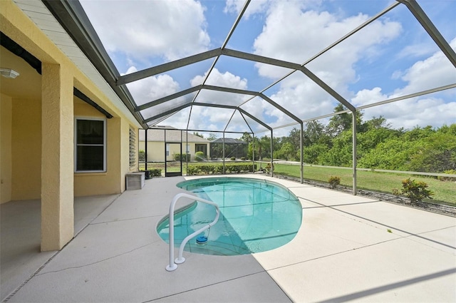 view of swimming pool with a lanai and a patio area