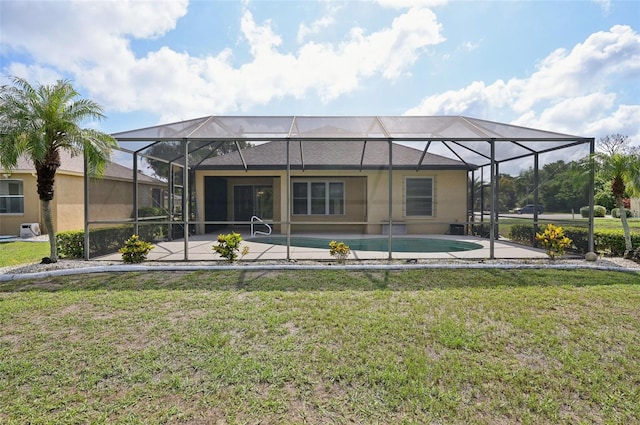 back of house with a lanai and a lawn