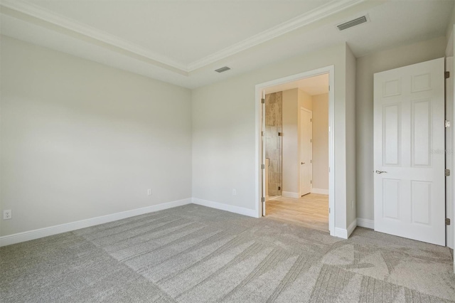 unfurnished bedroom with ensuite bathroom and light colored carpet