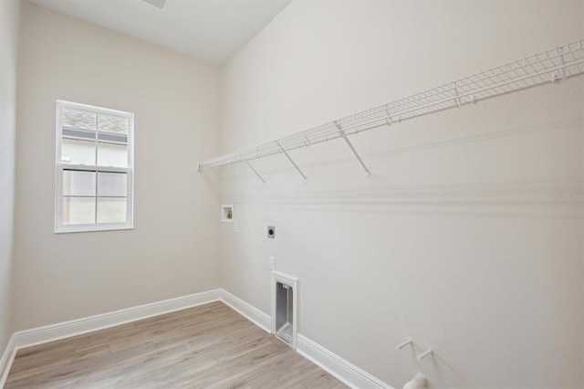 laundry area with hookup for a washing machine, electric dryer hookup, and light hardwood / wood-style flooring