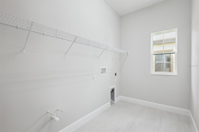 washroom with electric dryer hookup, washer hookup, and light wood-type flooring