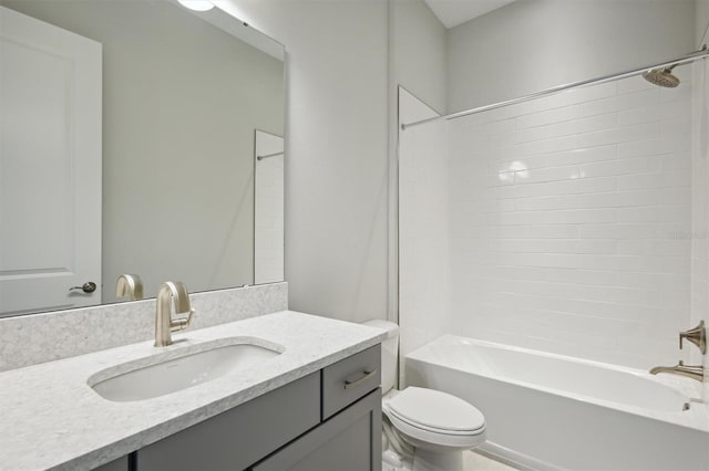 full bathroom with tiled shower / bath, vanity, and toilet