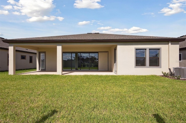 rear view of property featuring central air condition unit, a patio area, and a yard