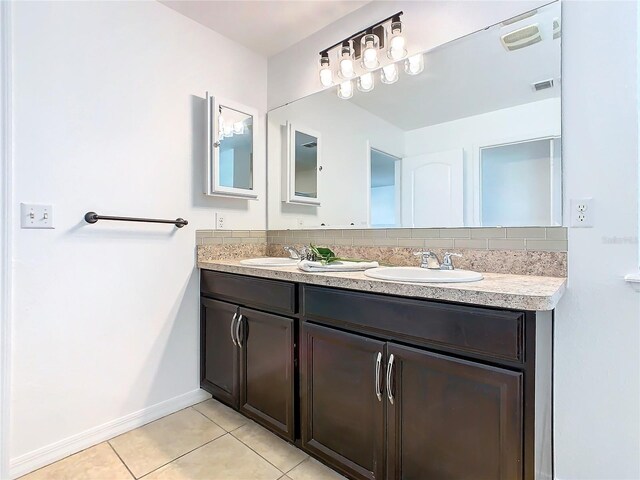 bathroom with backsplash, vanity, and tile patterned flooring