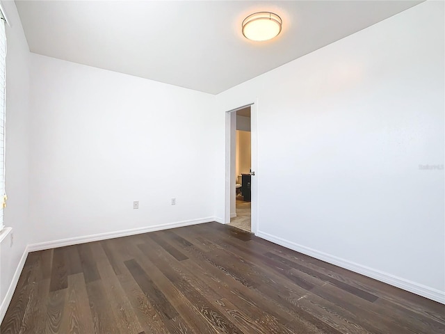 spare room with dark hardwood / wood-style floors