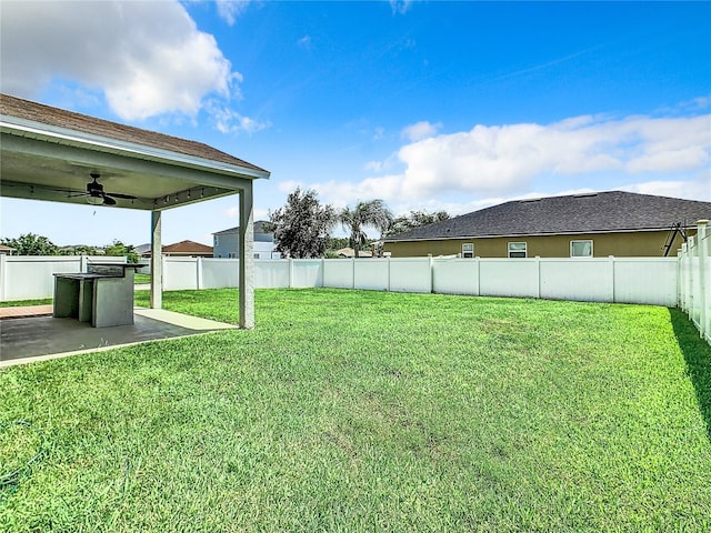 view of yard with ceiling fan and a patio area