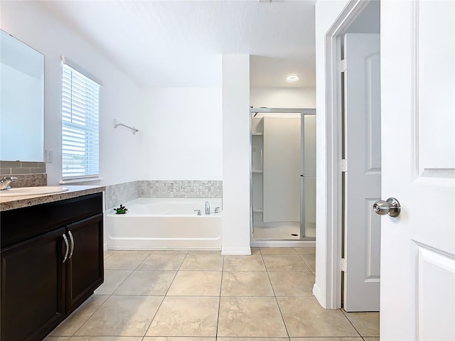 bathroom with tile patterned floors, vanity, and separate shower and tub