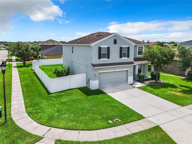 view of front of property with a garage and a front lawn