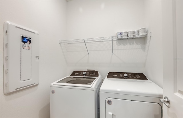 clothes washing area featuring washer and dryer and electric panel